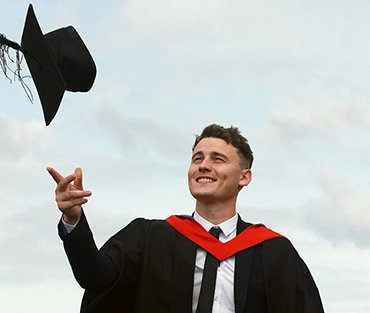 Graduate throwing cap